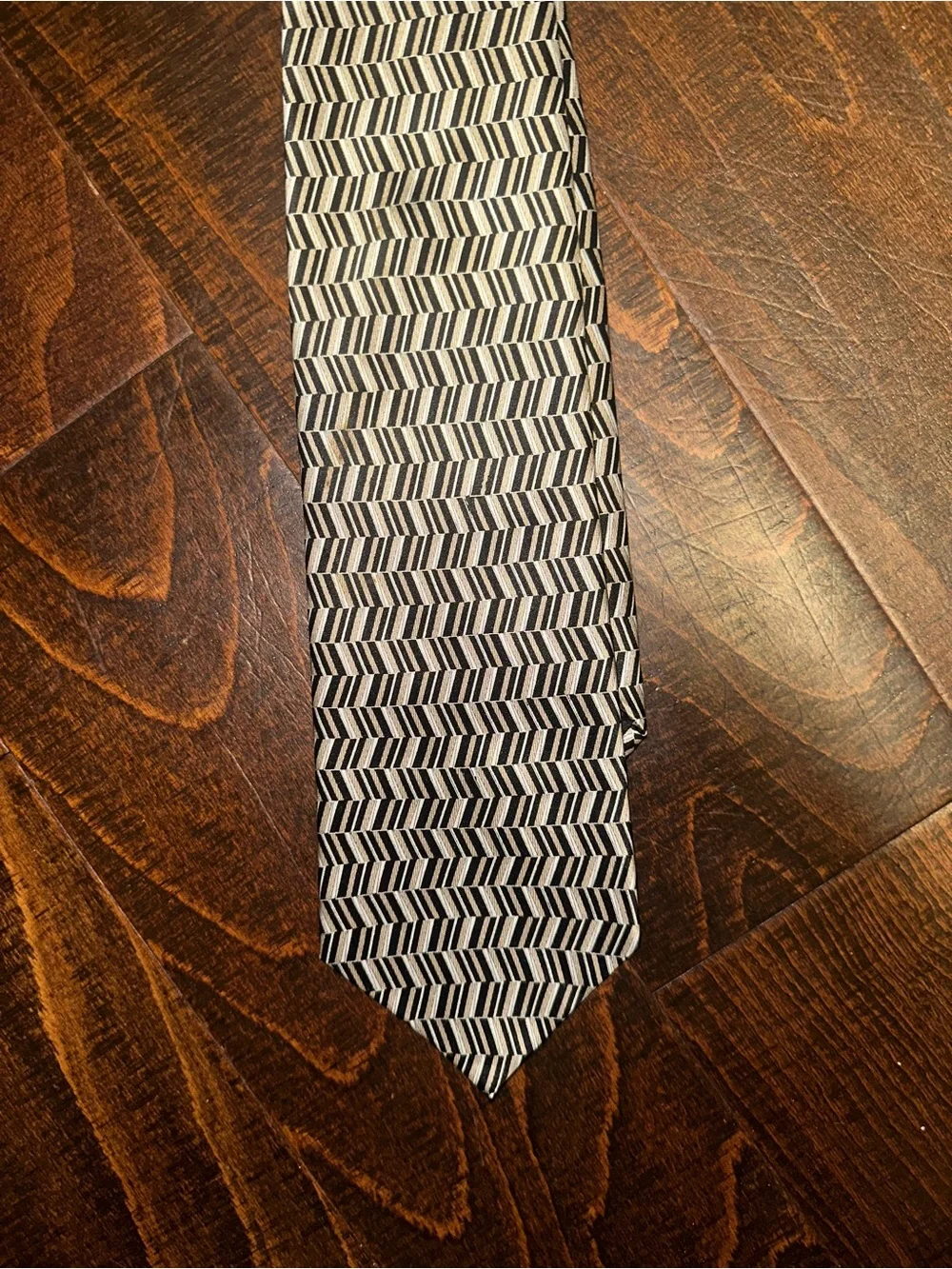 VAN Heusen necktie features black, beige, and grey geometric herringbone pattern